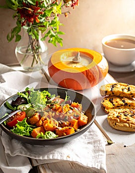 Pumpkin dish with a salad and biscuits
