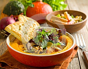 Pumpkin dish with a salad and biscuits