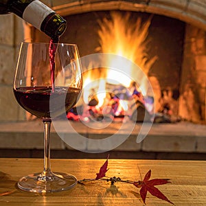 Art pouring wine by the fireplace