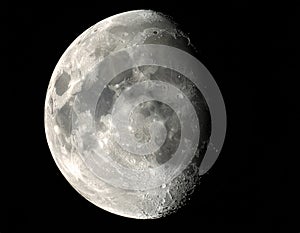 The image shows a detailed view of the Moon, illuminated on the left side