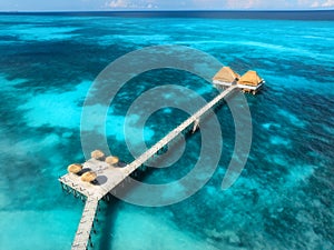 Aerial view of bungalow, jetty, blue sea on summer sunny day photo