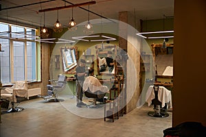 Barbershop interior with working coiffeur photo