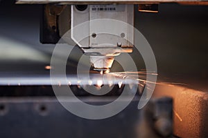close-up of a laser cutter cutting through metal sheet