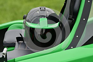 Helmet on a two-seater green gyrocopter at the airfield photo