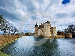 Majestic castle Sully sur Loire surrounded by water under clouds photo