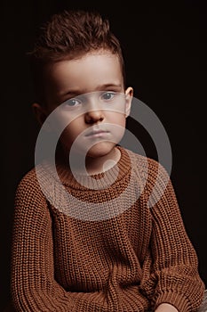 Portrait of serious sad stylish white caucasian child boy kid preschooler