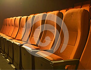 Generated image. A row of seats in an empty theater.