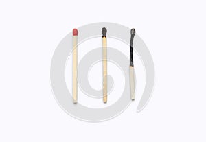 Three matches isolated on a white horizontal background