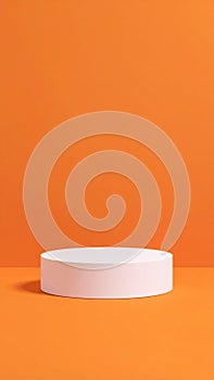 Vibrant orange backdrop with clean white cylinder stage for minimalist product display
