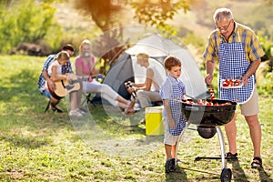 Generation family cooking on grill