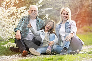 Generation Family On Grass Together in the garden