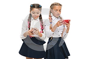 Generation of mobile communication. Little pupils using mobile devices isolated on white. Small schoolchildren having e