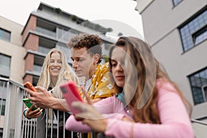 Generation z students hanging out together outdoors in the city.