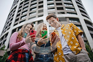 Generation z students hanging out together outdoors in the city.