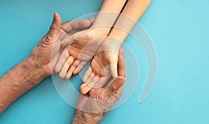 Generations Holding Hands Showcasing Family Unity Against a Blue Background