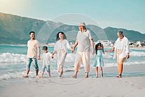 Generations, holding hands and walking family on beach and ocean waves, freedom and bonding in nature. Grandparents