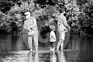 Generations men. Grandfather, father and son are fly fishing on river.