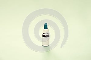 Generic bottle of essential oil in neutral green backdrop. CBD or THD oil, natural health products, calming supplements, copy