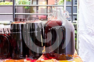 Generic bottles of Canadian maple syrup liquid natural, edible tree sap, being sold outdoors at a vendor table during the winter