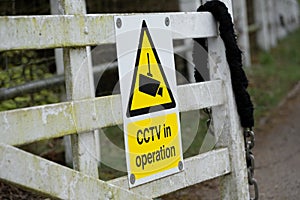 Generic CCTV Warning Sign seen attached to a garden fence at a rural location.