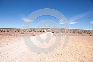 Generic desert scene with path to horizon photo