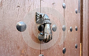 Generic hand shape Metal door knock on timber door