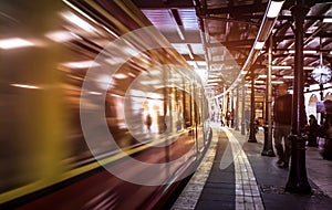 Generic metropolitan platform in Berlin - Urban transportation concept with blurred vehicle moving at underground subway station