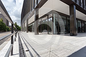 Generic office building in a plain urban downtown area with clouds