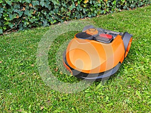 Generic orange robot lawn mower for automatic mowing grass