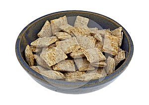 Generic shredded wheat cereal in a stoneware bowl