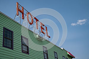 Generic sign for a Hotel on the top of a building. Artistic angle against blue sky