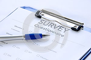 Generic survey questionnaire on clipboard with pen