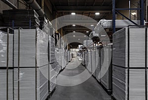 Generic warehouse industrial interior with palettes stacked on shelves. Wide angle view