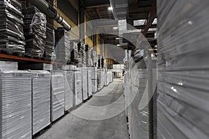 Generic warehouse industrial interior with palettes stacked on shelves. Wide angle view