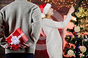 Generosity and kindness. Prepare surprise. Winter surprise. Man carry gift box behind back defocused background