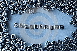 Generosity - Word from Metal Blocks on Paper