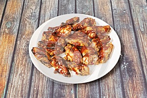 Generous serving of fried chicken wings topped with barbecue sauce