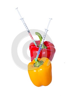 Genetically modified vegetables. GMO food concept. Syringes are stuck in vegetables with chemical additives.