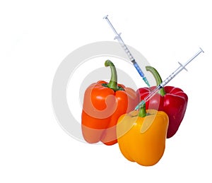 Genetically modified vegetables. GMO food concept. Syringes are stuck in vegetables with chemical additives. Injections into fruit