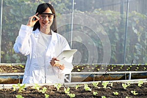 Geneticists  biologists  and scientists holding tablets in the nursery photo