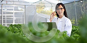Geneticists, biologists, and scientists are studying the genetic structure of vegetables in a greenhouse photo
