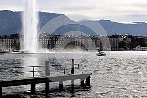 Geneva cityscape pier and Water jet dEau Water Fountain and facades in winter