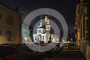 Geneva street with parked cars and Russian orthodox church Eglise Russe  at night time, Geneva, Switzerland