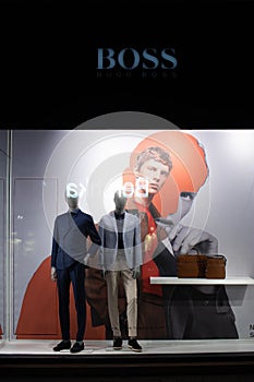 Hugo Boss fashion store, exposition, window shop with modern bags, clothes, shoes from Hugo Boss fashion house