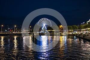 Geneva, Switzerland 8 September 2023: Night riverside view with beautiful reflections of Geneva city, Switzerland