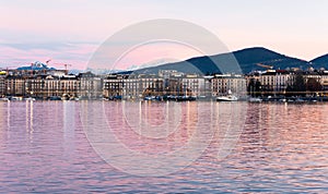 Geneve. Switzerland - December 30, 2021: View of the evening embankment of Geneva on Lake leman