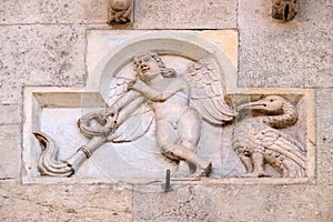 Genio Funerario with upside-down torch around 1099, bas-relief by Wiligelmo, Modena Cathedral photo