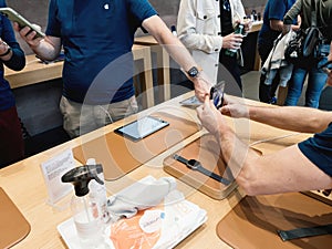 Genius Apple worker wearing new titanium Apple Watch Ultra during launch day -