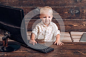 Genius child type computer keyboard. Genius toddler use new technology in kindergarten. In touch with tomorrow