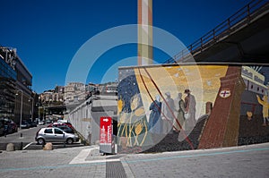 Mural depicting emigrants leaving Genova and lighthouse - symbol of city